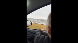 Strong ocean waves splash onto car in New Jersey, USA