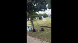 Police officers carry stray dog for vaccination in Córdoba, Argentina