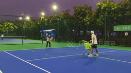 Tennis coach whacked in face by wayward shot