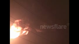 Factory chimneys emitting a huge fireball lit up the night sky