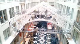 Giant letter C being hoisted above historical Curtis Center lobby in Philadelphia