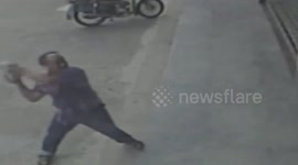 Man filmed trying to smash a bank door with a brick in China