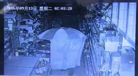 Cloaked thief, armed with umbrella steals cigarettes from newsagents