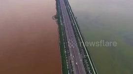 Salt lake turns two different colours on either side of road
