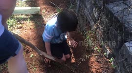 Kid gets stuck in hole and has to be dug out