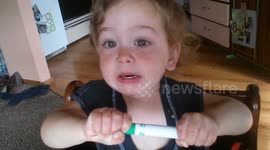 Hilarious Toddler Struggles to Remove Top from Marker