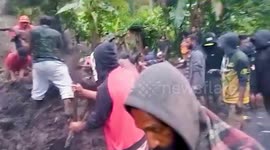 Landslide kills 21 and leaves dozens more trapped in Papua