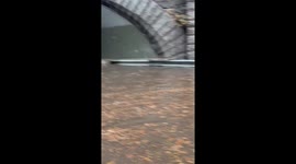 Vehicles navigate flood on West Side Highway in New York, USA