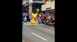 Pikachu outruns Stitch in a playful mascot race on Session Road in Baguio, Philippines