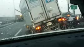 Lorry, stuck in traffic jam, tips over during Typhoon Megi