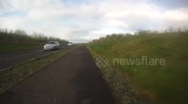 Driver on wrong side of road nearly crashes head-on with cyclist and car