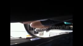 Coach driver uses feet to drive on motorway