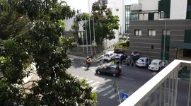 Car doesn't stop at policeman sign and almost hits bikers