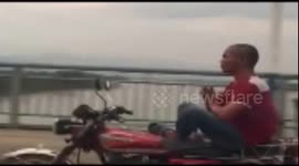 Man meditates on a moving motorbike