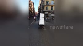 Two men filmed trying to transport a fridge on a motorbike