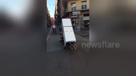 Two men filmed trying to transport a fridge on a motorbike