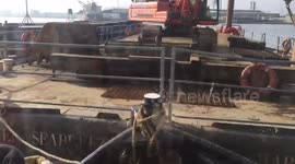 Tug pushing crain barge