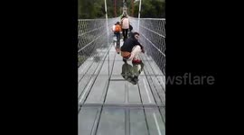 Chinese tourists get really scared walking on glass bridge