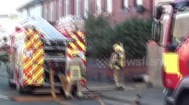 blackpool house fire  shows unconcerned man in window waving