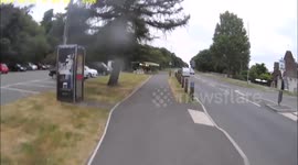 Car ignores bike on cycle path and drives across in front