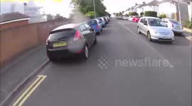 Pedestrians walk in front of cyclist in the road