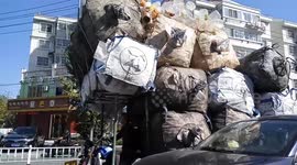 This vehicle in China is ridiculously overloaded