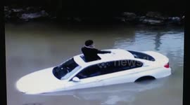 BMW ends up in river after driver presses accelerator by mistake