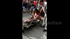 Woman's long dress gets stuck in motorcycle