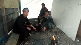 Refugees cooking in Grande Synthe Migrant Camp, France