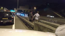 Couple wait to cross busy M25