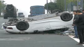Car turns over after drives onto a well on road
