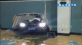 BMW crashes through stadium wall, narrowly missing basketball player