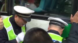 A group of people lift up a bus to release a girl trapped under it