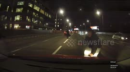 Driver narrowly avoids pedestrians crossing busy road