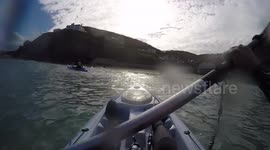 Boys out fishing on a kayak and then huge waves knocks mate off and into the sea!