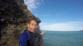 Boys cliff jumping into the sea in Portreath Cornwall