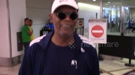 Samuel L Jackson tries to avoid the paparazzi as he arrives at LAX Airport in Los Angeles, Ca