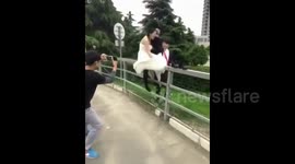 Bride and groom fall over during wedding photoshoot