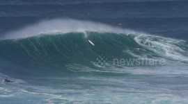 English Surfer falls off board on giant wave in Nazare