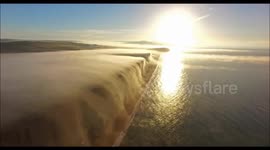 Drone Captures Beautiful Time Lapse Of Mist Flowing Over Cliffs Like A Waterfall