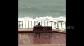 Huge waves cover people who thought they were safe on promenade
