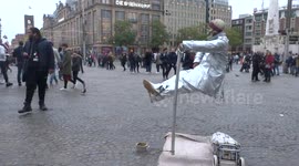 Street performer levitates in Dam Square, Amsterdam