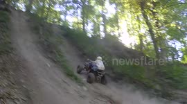 Quad biker attempts steep ascent and fails badly