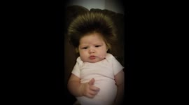 Baby born with full head of hair gets the blow-dry treatment