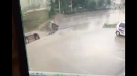 Two cars drop into sinkhole caused by road collapse