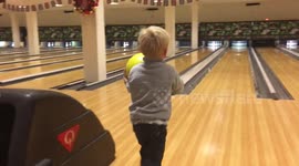 Four-year-old Danish boy jumps for joy when he scores a strike after slipping over
