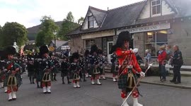 Braemar Gathering 2016 - Royal Highland Society members led by Ballater & District pipe band to highland games field