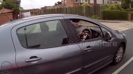 Scooter rider catches woman looking at mobile phone while driving