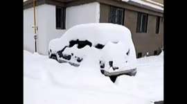 Heavy snow buries vehicles on road in northern China