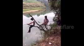 Man playing tricks on his fishing mate falls into river